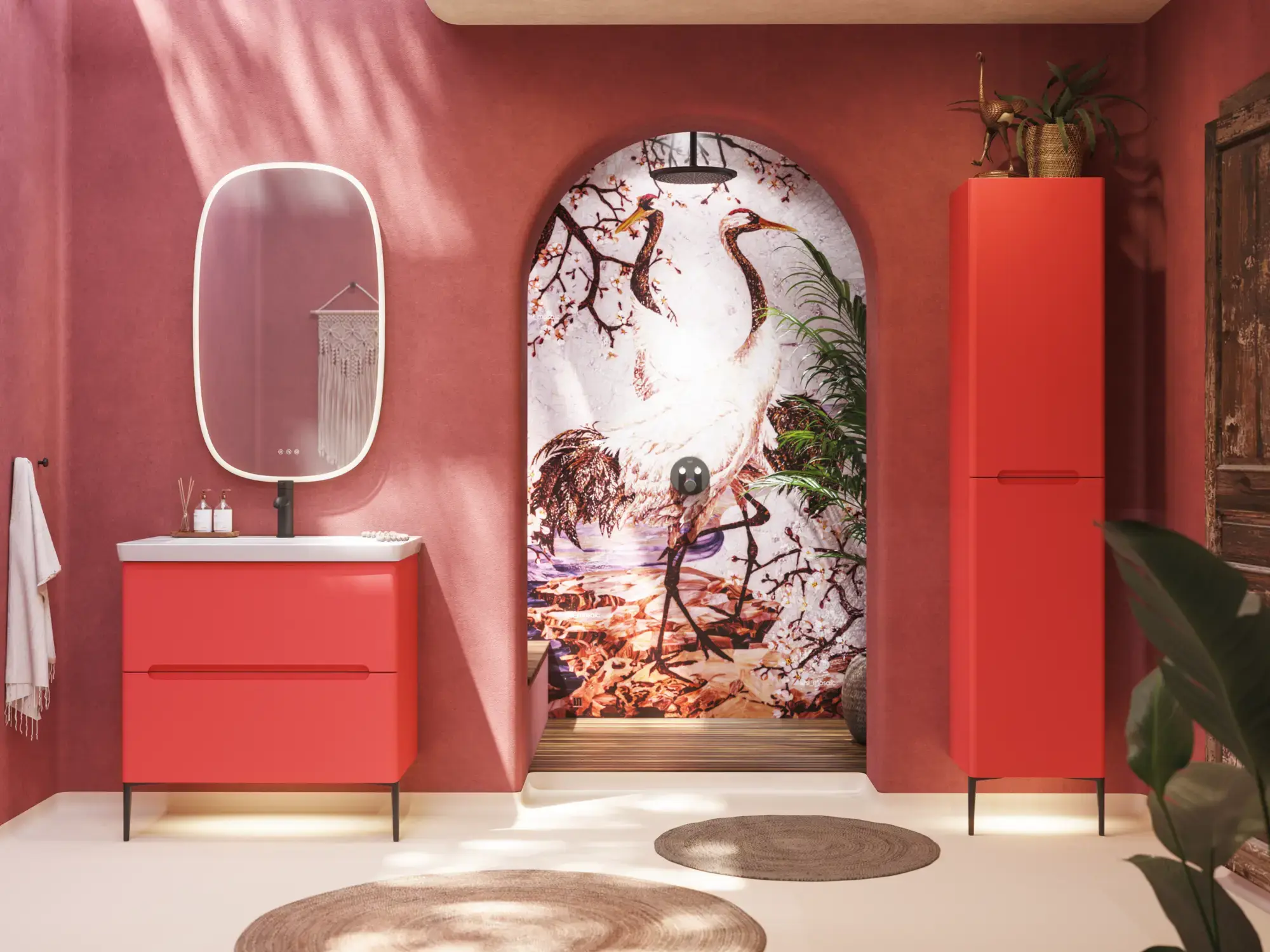 Badkamerinspiratie met rode muren, zacht gevormde rode wastafelmeubel en hoge kast, elegante witte wastafel en een prachtige ovale spiegel met licht die samen met de natuurlijke omgeving een vintage uitstraling creëren