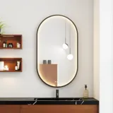 Moderne en stijlvolle badkamer inspiratie met ovale spiegel met zwarte lijst en lichtregeling, gekleurd toilet, wastafelmeubel, onderkasten en kasten in roodbruin eiken, Silestone wastafel en bijpassende vloer