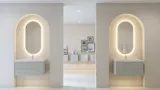Stijlvolle en moderne badkamer inspiratie met ovale spiegels met lichtregeling, stenen wastafels en wastafelmeubels met elegante groeven in een minimalistisch ontwerp, lichte en luchtige sfeer met elegante verlichting en verfijnde details